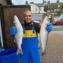 Fresh fish held outside The Little Blue Hut