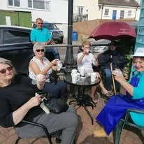 Customers relaxing outside The Little Blue Hut