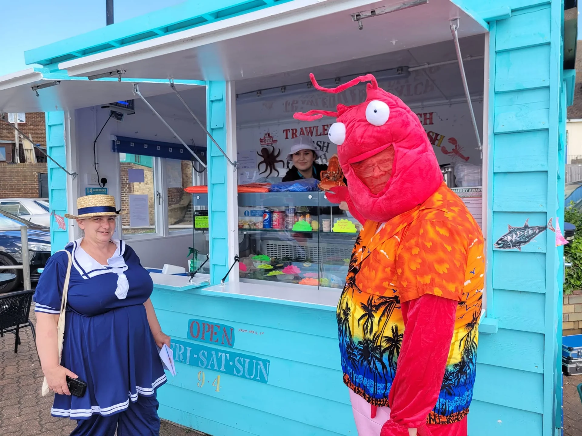 The Little Blue Hut team with a colourful lobster character